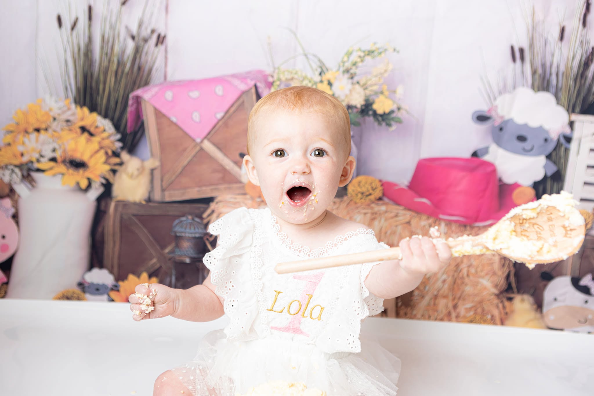 Baby girl enjoying her cake smash session