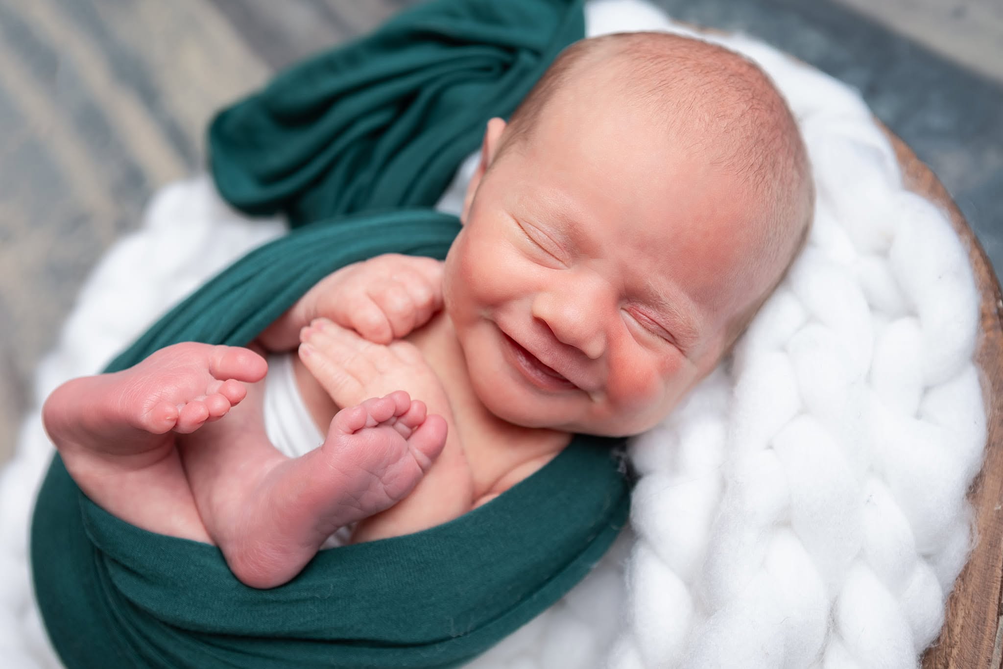 Newborn baby smiling during a studio session