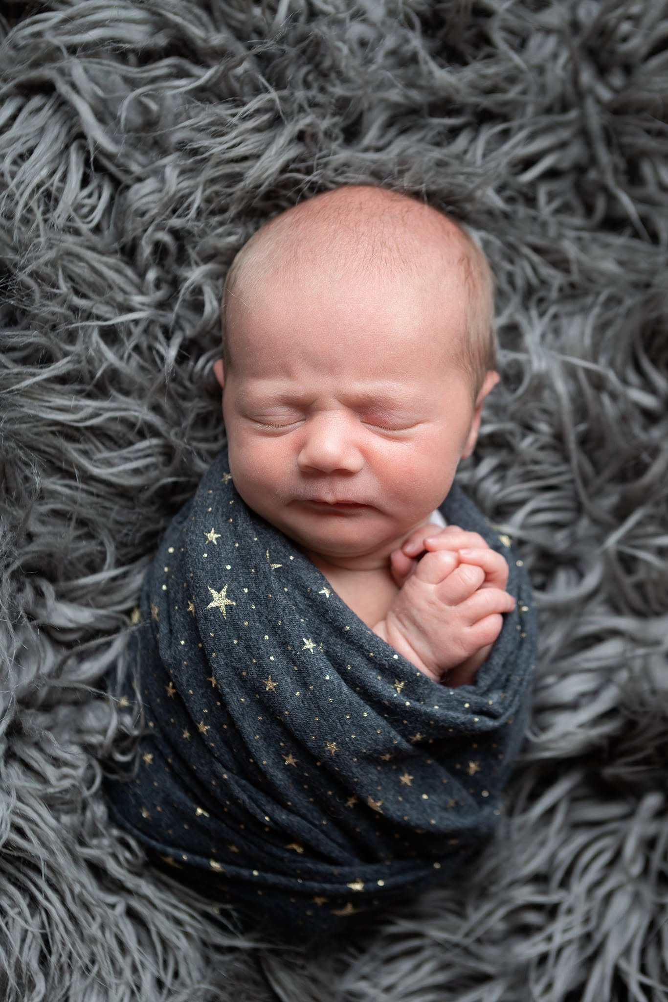 Newborn baby wrapped in a cozy swaddle