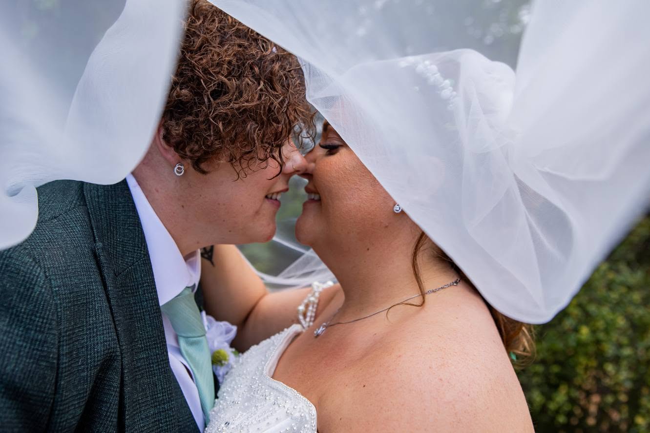 Bride and groom sharing a kiss at the altar